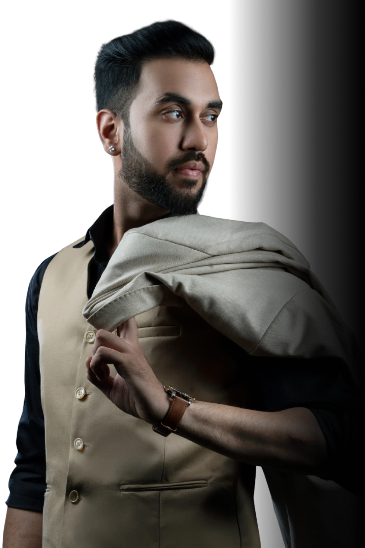 Rayan Malhotra in a waistcoat, jacket over one shoulder, looking off to the side